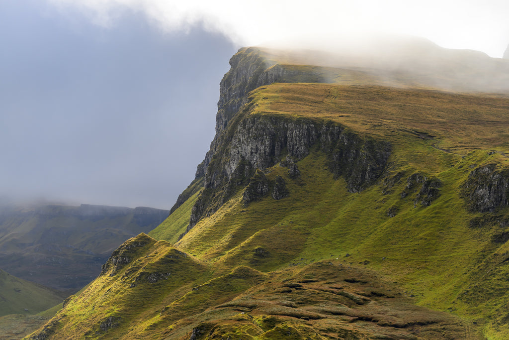 Rocky cliffs in misty sunshine at The Quiraing under acrylic glass with black frame